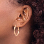 將圖片載入圖庫檢視器 14k Rose Gold Diamond Cut Round Hoop Earrings on a Model